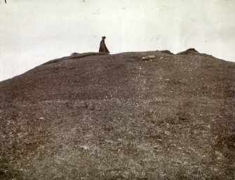 Photograph, distant view of woman standing on top of Elsay Broch. 