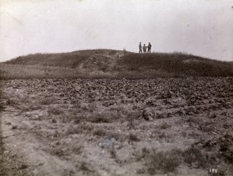Distant photograph of men at Kilminster Broch (mound).