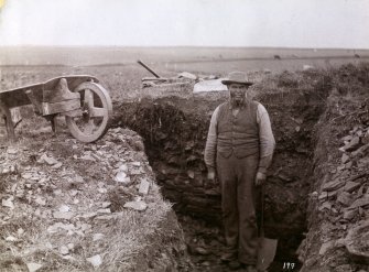 Photograph of a man at Kilminster Broch (mound).