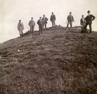 Photograph, men standing on Kilminster Broch (mound).