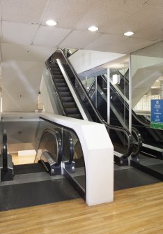 Interior.  Fourth floor.  View of escalators from south.