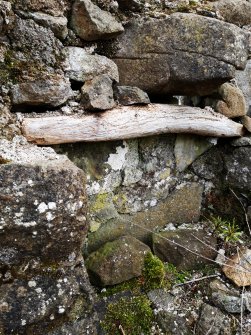 View of an alcove in the SW end of the compartment at the SW end of the farmhouse, showing a displaced timber lintel.