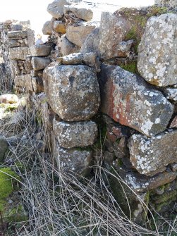 View from NW showing the junction of two walls. On the right of the image is the NW side of a doorway in the SE side of the byre. Coming up to meet it from the SE and partly overlap it is the later SW wall of the building that stands on the NE side of the courtyard.  