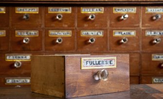 Coldstream, 61 High Street. Interior. Pharmacists medicine drawer. Detail showing 'FULLERS E.[arth]' drawer label (painted and gilded glass).