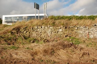 Watching brief photograph, A935 Road widening, Mill of Dun, Montrose, Wall context 10,  W end, at site of former Dun Mill Cottage