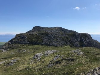 Eigg, An Sgurr, fort. General view looking E; the fort wall crosses from left to right mid-way up the slope. 