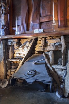 Interior view showing Skara Brae-inspired fireplace in living room on ground floor of house at The Steading, Nether Blainslie.