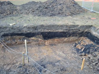 Watching brief, S facing section of gas pipe trench showing layers of coal dust from NE, M8 enabling works, Coatbridge