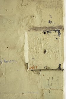 Detail of incised graffiti in cell 8. 
