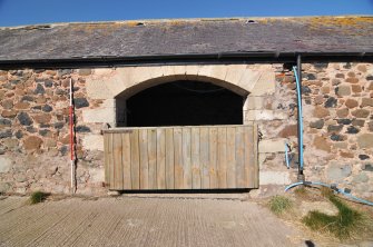 Historic building survey, N-Range, S-facing elevation, segmented arched doorway with rebuilt quoins, Crunklaw Steading, near Duns, Scottish Borders