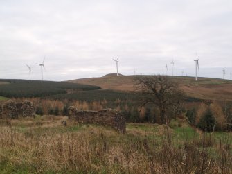 Cultural heritage assessment, General view of site 6 (farmstead) with Ardrosan Wind Farm and Knock Jargon fort beyond, Blackshaw Community Windfarm