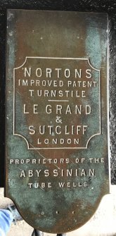 Detail of turnstile maker's nameplate.