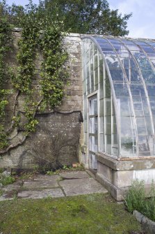 View from south showing curved glasshouse from in gardens at Brechin Castle.