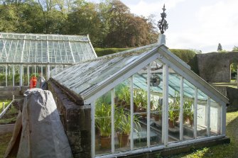 View from west showing glasshouse in garden, Brechin Castle.