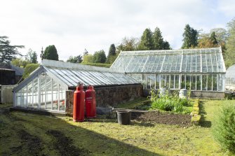 View from east showing glasshouses in garden, Brechin Castle. 