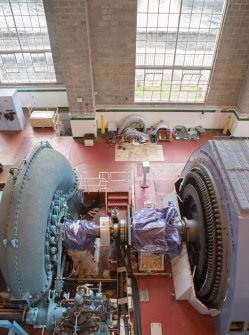 Interior.  Turbine Hall. Ground floor. Elevated view of generator set MC1, note alternator with its casing removed (right)