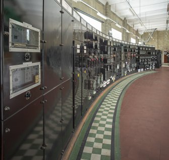 Interior view of Tummel Bridge hydroelectric electricity generating station.  Mezzanine/First floor.  View from east of central control panel