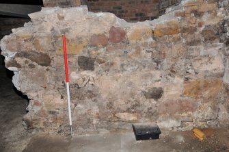 Standing building appraisal, Room 1/5, Reduced rubble-built partition wall above the flagstone floor, 85-87 South Bridge, Edinburgh