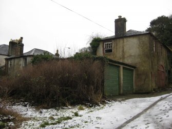 General view of garages and storehouse in lane to north-west of Nos 22-26 High Road, Port Bannatyne, Bute.