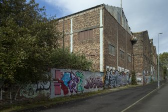 General view of graffitti wall on southside of Dunnikier Works from west.