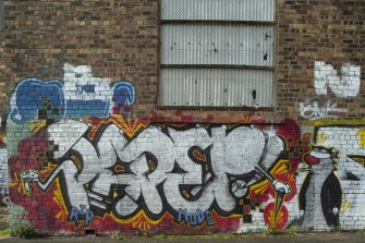 Detail of graffitti wall on southside of Dunnikier Works.