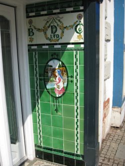 Detail of Buttercup Dairy Company tiling in doorway of Nos 136 and 138 High Street, Dunbar.