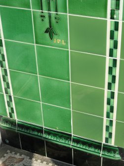 Detail of makers' mark 'J. D.(uncan) Ltd.' on Buttercup Dairy Company tiling in doorway of Nos 136 and 138 High Street, Dunbar.