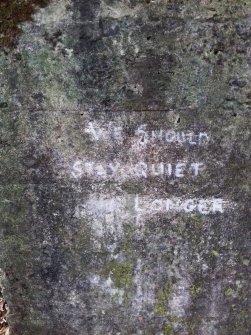 View from NE of the graffiti on the NE side of the slotted concrete block that forms the NW side of the roadblock.