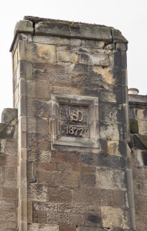North east elevation. Detail of 1877 datestone with initials WSD (?) to chimney stack. 