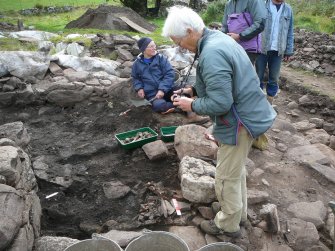 A team member photographs bone deposit