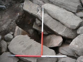 Fallen slab: overburden removed to reveal cut of passage