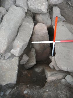 Fallen slab: overburden removed to reveal cut of passage