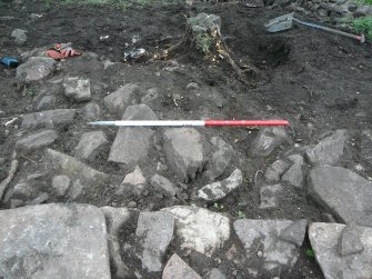 Outside north part of outer wall, rubble, outer face of OW in foreground, looking down from above