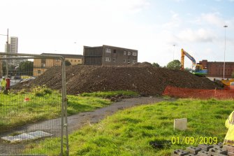 Archaeological evaluation, General shot of spoil bund and knotweed obstruction, Anderston, Glasgow