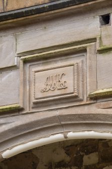 Exterior.  Detail of crest above entrance, from west.