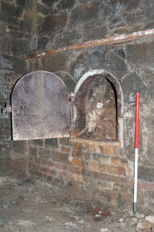 Historic building survey, General view of drawhole 11c in the N wall of kiln with door open, Limekilns, Harbour Road, Charlestown
