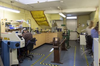 Interior. Third floor. Goldsmiths workshop. View of work benches and probable 19th century wire drawing/straitening machine.