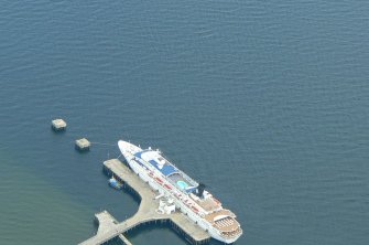 Oblique aerial view of cruise liner docked at Invergordon Pier, Cromarty Firth, looking SE.