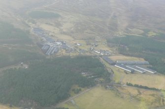 Oblique aerial view of Tomatin Distillery, S of Inverness, looking SW.