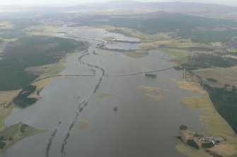 Oblique aerial view of flooded Strathspey between Broomhill/Nethy Bridge and Dulnain Bridge, looking NE.