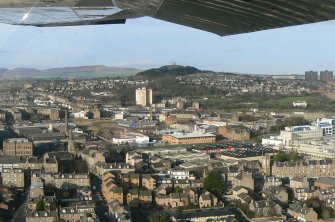 Low-level aerial view from west central Dundee towards Dundee Law and the Sidlaw Hills, looking N.
