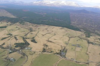 Oblique aerial view, looking NNW over the Heights of Fodderty in the foreground towards Ben Wyvis, near Dingwall.