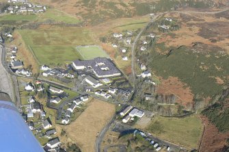 Close up aerial view of Gairloch at junction of A832/B8021, looking W.