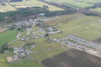 Oblique aerial view of Croy village, E of Inverness, looking SE.
