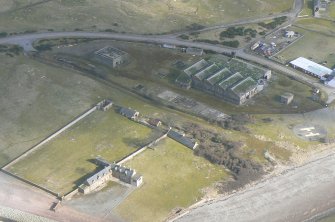 An almost oblique aerial view of the wartime buildings at Nigg ferry, Cromarty Firth, looking NE.