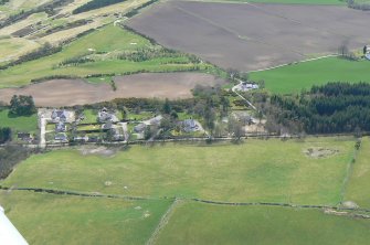 An oblique aerial view of the west part of Muir of Ord in Rosshire, looking SE.