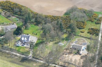 An oblique aerial view of the west part of Muir of Ord in Rosshire, looking SE.