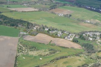 An oblique aerial view of the west extremity of Muir of Ord in Rosshire, looking N.