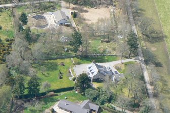 An oblique aerial view of the western extremity of Muir of Ord in Rosshire, looking N.