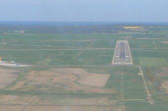 General oblique aerial view of Dalcross Airfield, E of Inverness, looking N.